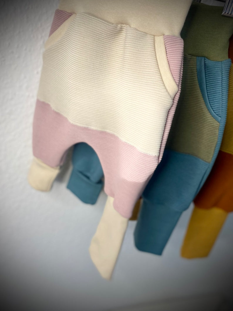 Drei Mix and Match Pumphosen für Kleinkinder in rosa, blau und rot.