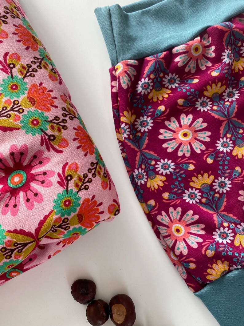 Pumphose für Kleinkinder aus Alpenfleece in Weinrot mit Blumenmuster.